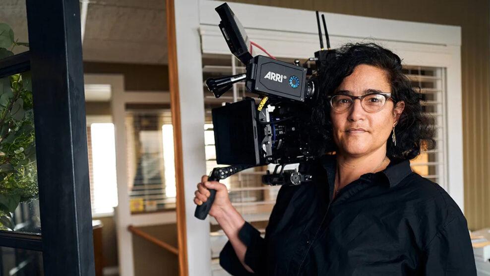 A professional filmmaker holding an ARRI camera, capturing content with precision and focus.