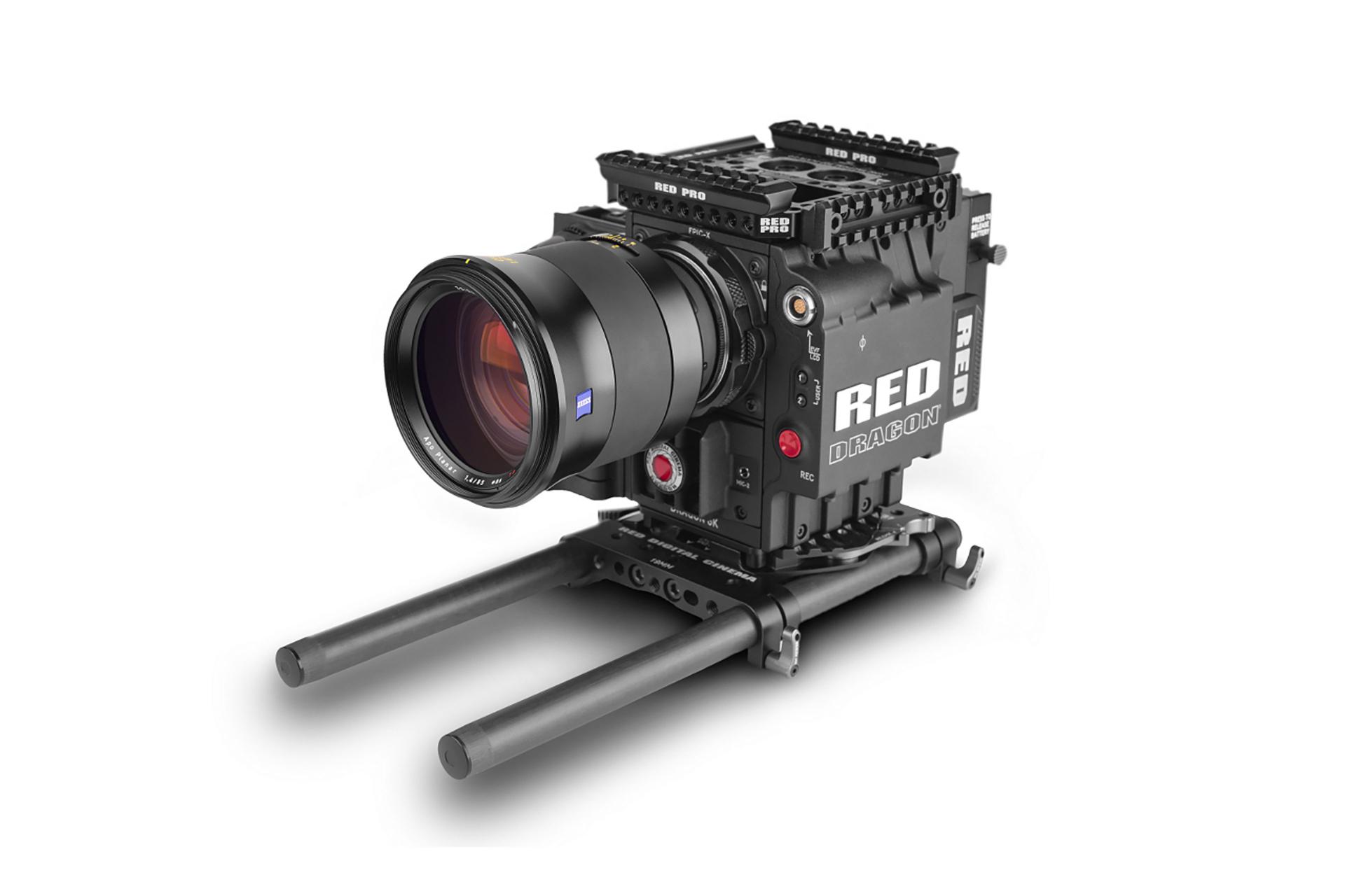 Professional cinema camera setup featuring a ZEISS lens mounted on a RED DIGITAL CINEMA camera body with rigging accessories.