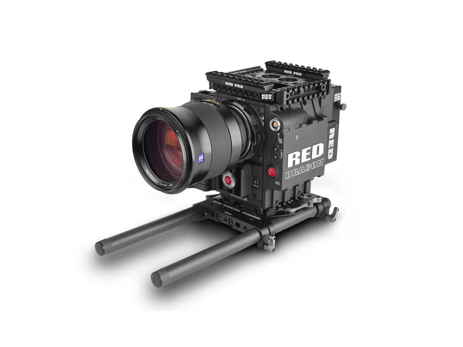 Professional cinema camera setup featuring a ZEISS lens mounted on a RED DIGITAL CINEMA camera body with rigging accessories.