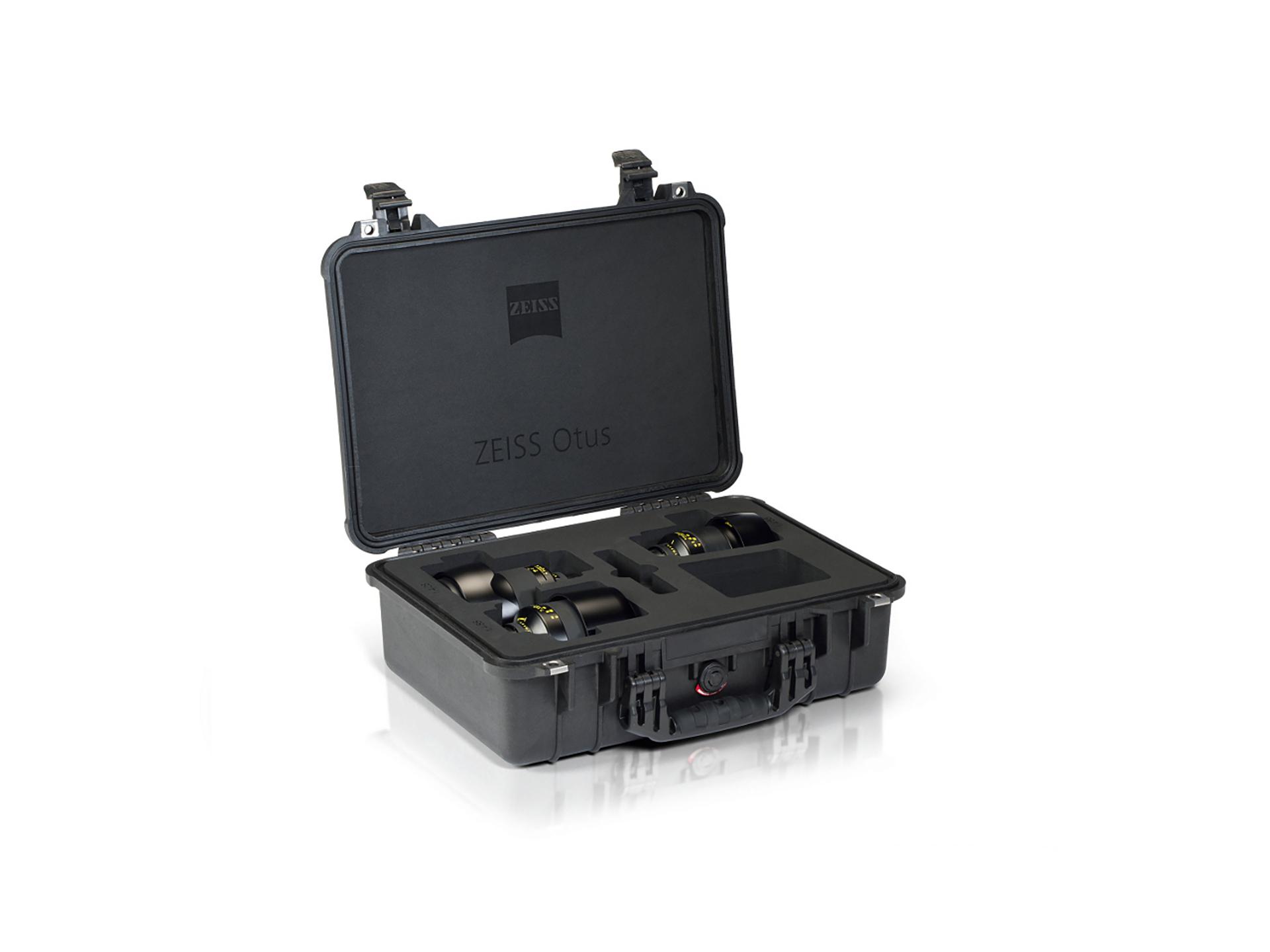 Black hard-shell case with custom foam insert holding four ZEISS Otus camera lenses, with the case lid open displaying the ZEISS logo.