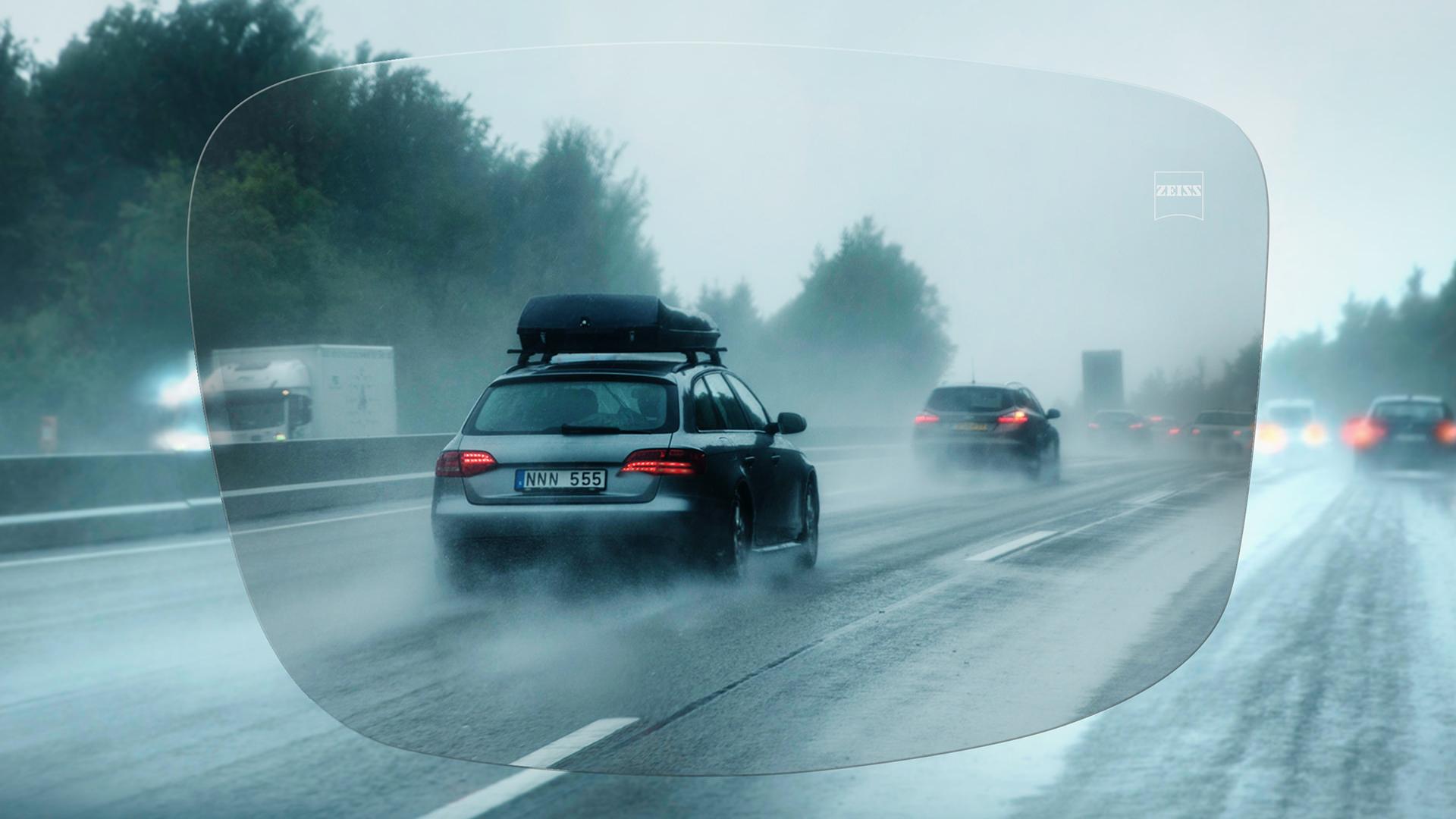 Vista a través de una lente monofocal ZEISS DriveSafe de una carretera en un día de lluvia 
