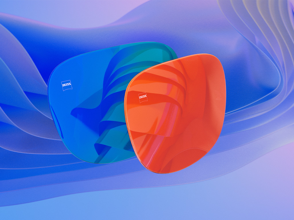 Ilustración en 3D generada por ordenador de dos lentes de sol con tratamiento espejado azul y naranja.