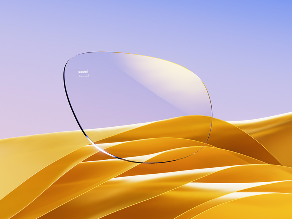 Una representación CGI de una lente transparente con un sutil reflejo dorado.