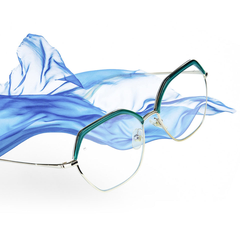 Imagen de unas gafas con lentes progresivas ZEISS Light 2 y una tela azul en el aire.