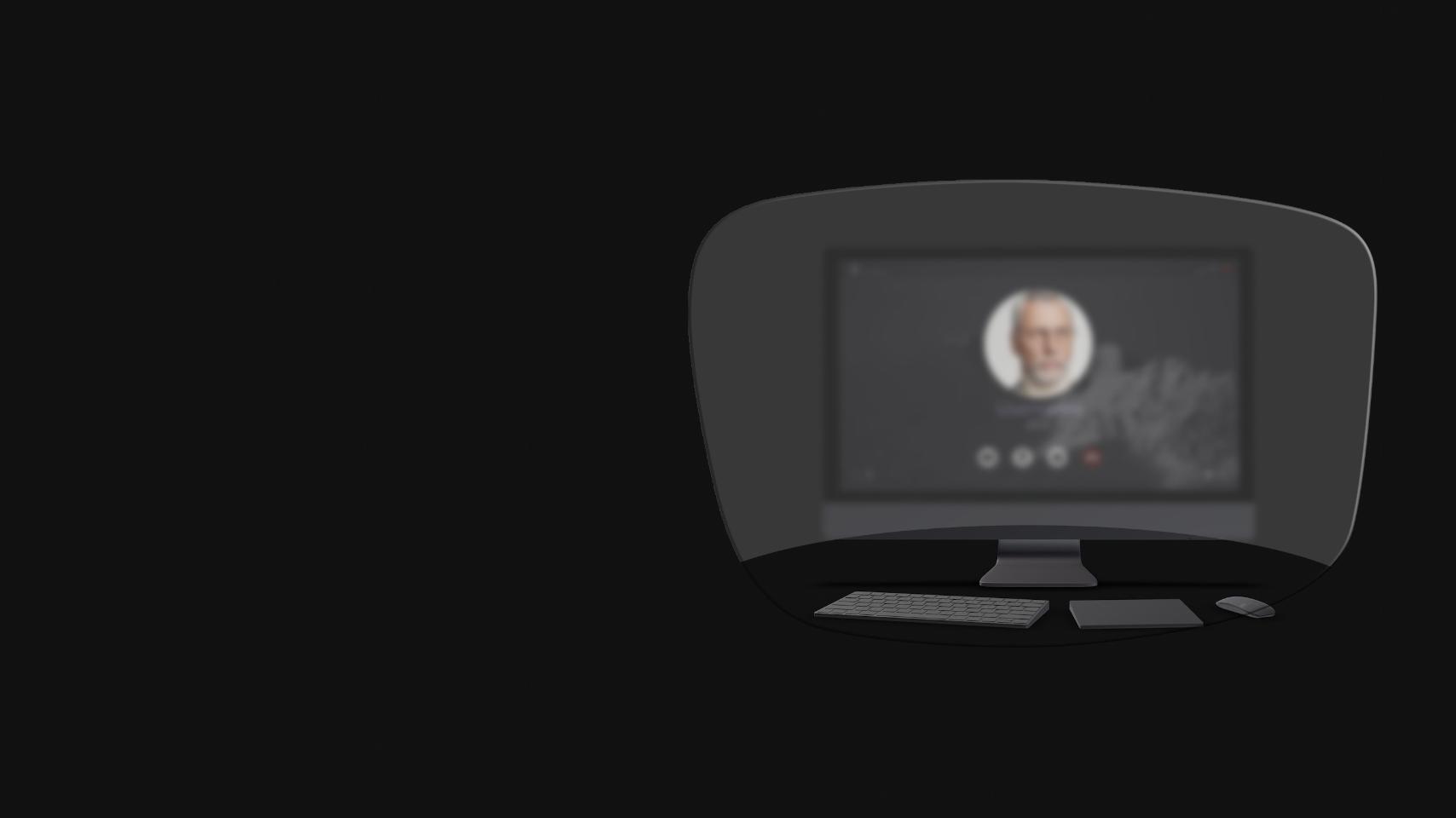 La vista de un ordenador de sobremesa, un teclado, un ratón y un libro a través de un esquema de unas gafas de lectura muestra que solo los objetos cercanos son claramente visibles. La pantalla del ordenador está borrosa.