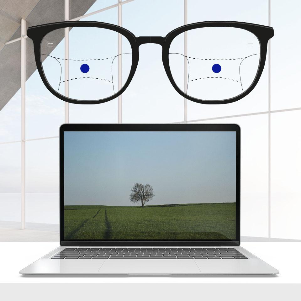 Una montura con lentes progresivas y líneas esquemáticas para indicar las distintas zonas de visión. Se diferencian partes de la lente: intermedia - parte central de las gafas.